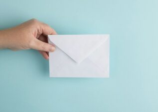 person showing white envelope